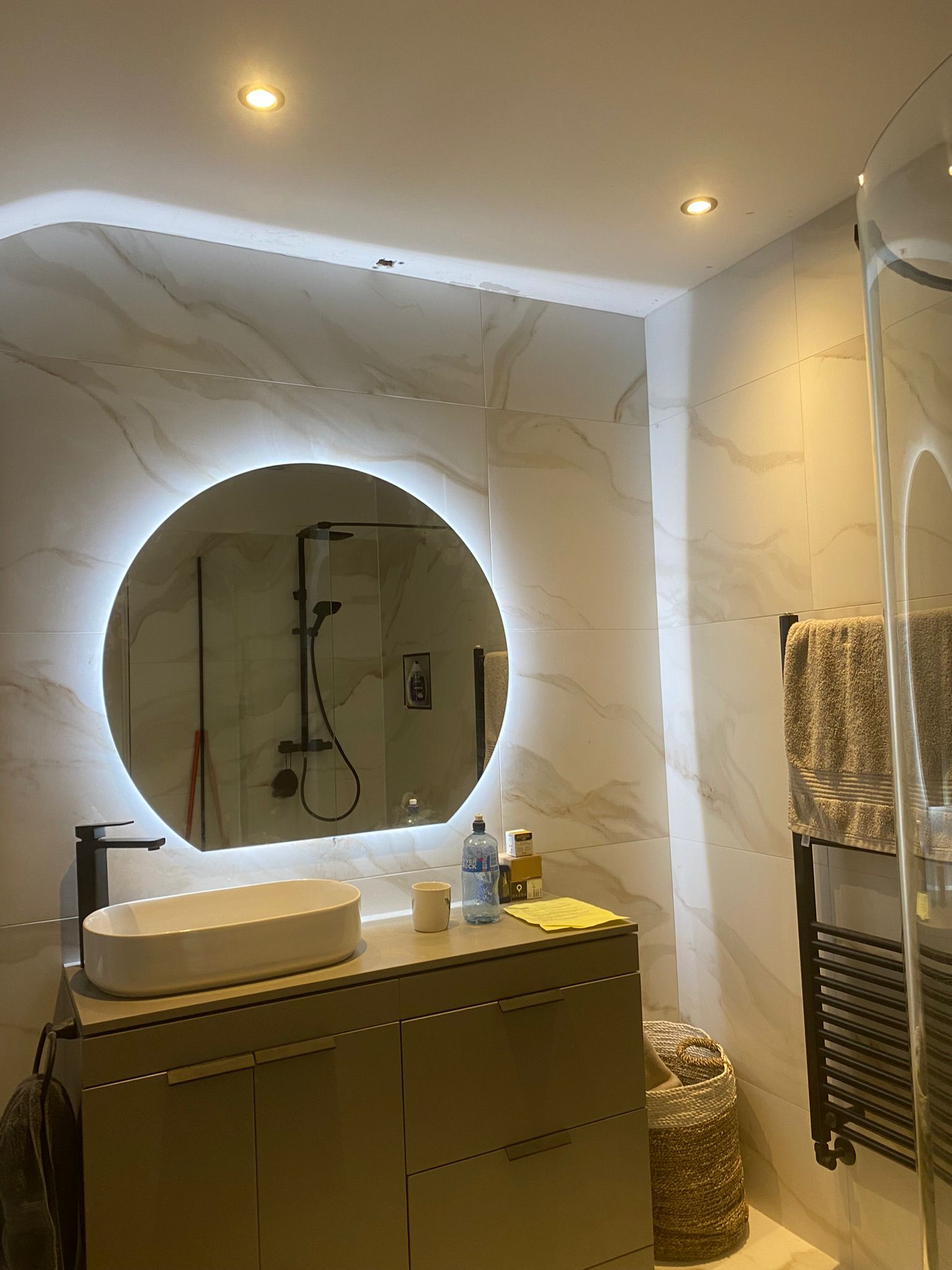 a bathroom with a round mirror