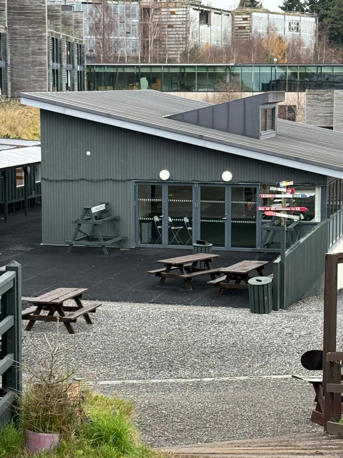 a building with picnic tables and benches